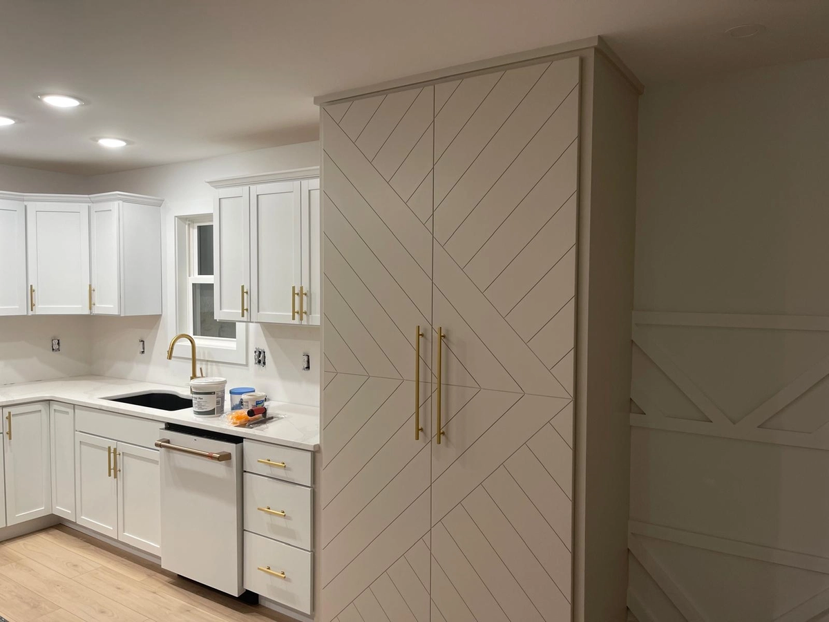 Full-height cabinetry with diagonal panel detailing and integrated storage