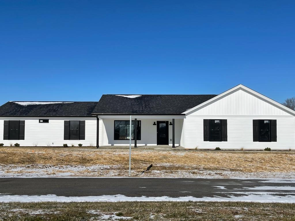 Front elevation showing the covered porch and attached garage at 8215 Salem Church Road