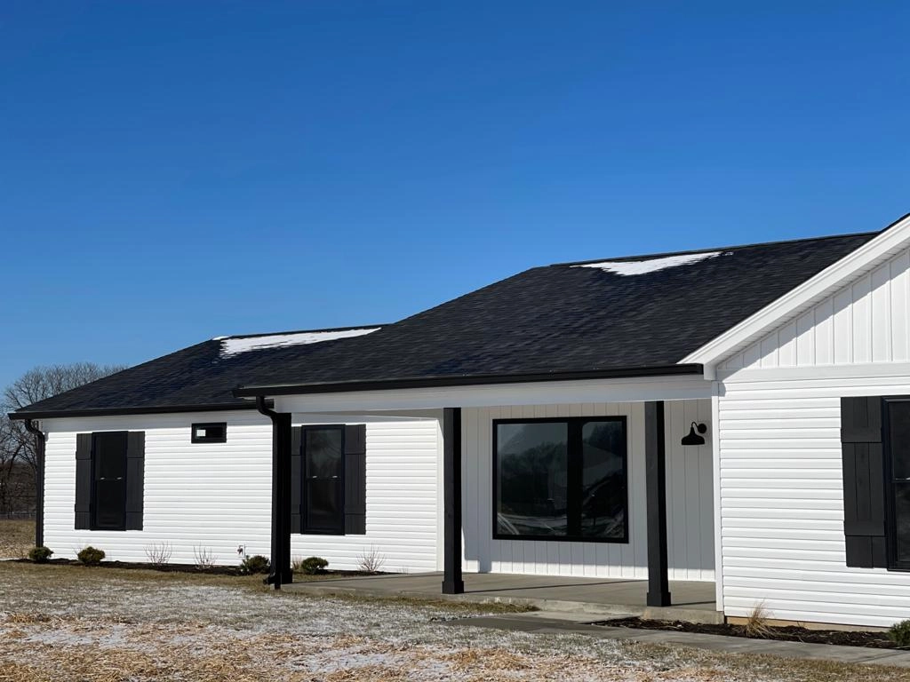 Covered front porch with dark shutters and glazed entrance at 8215 Salem Church Road