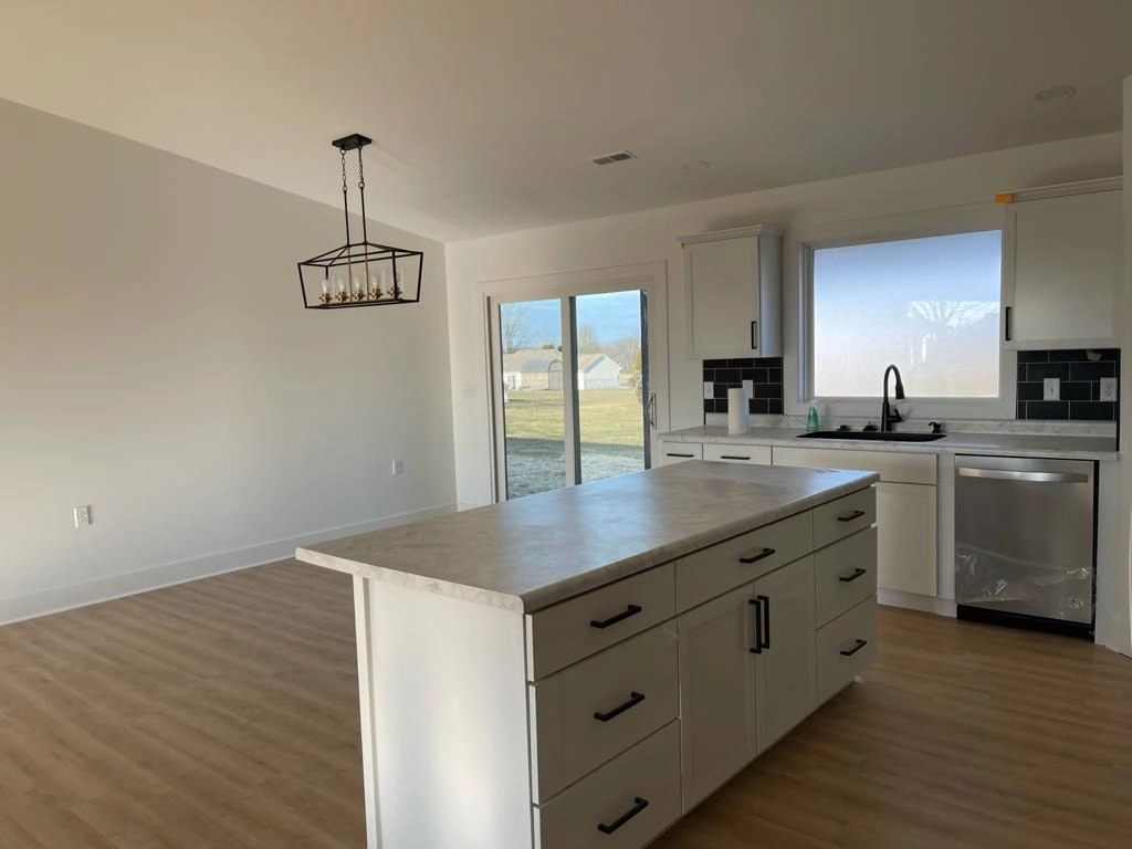 Kitchen island facing the adjacent living area at 8215 Salem Church Road