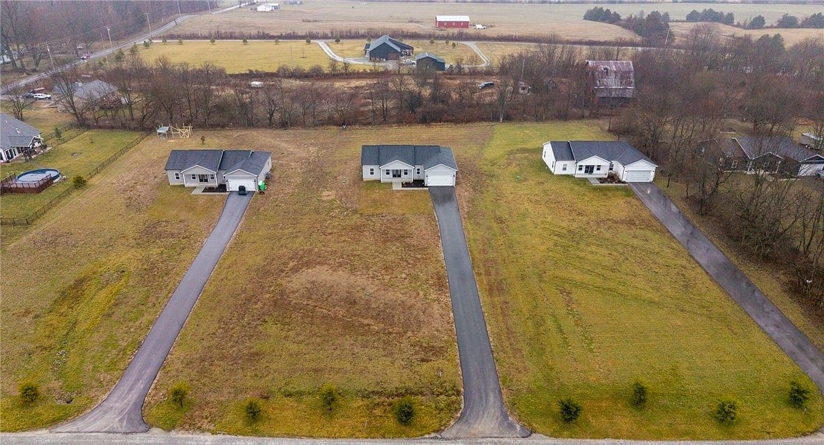 Aerial view of three neighboring homes and their driveways at 5608 High Jackson Road