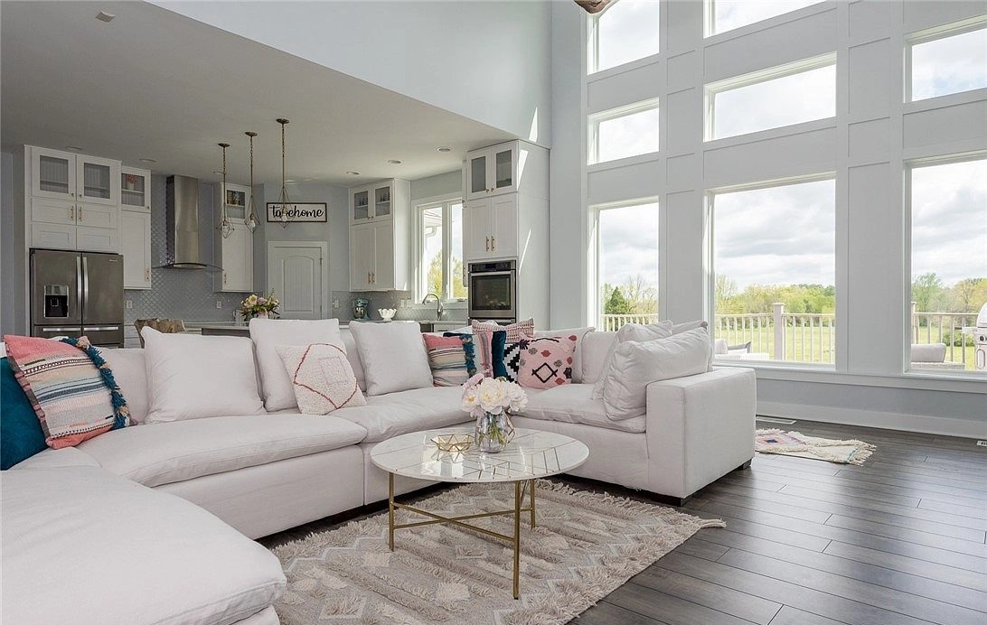 Sectional sofa in the tall living room, with the kitchen visible beyond