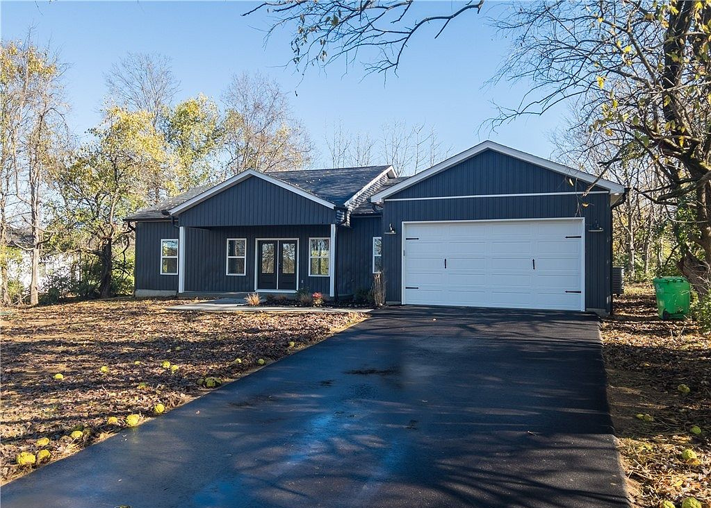 Blue home framed by autumn trees at 5612 High Jackson Road