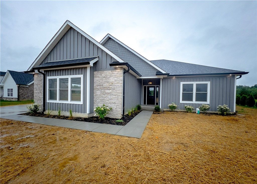 Home with a stone entry and covered porch at 676 Sun Studio Drive